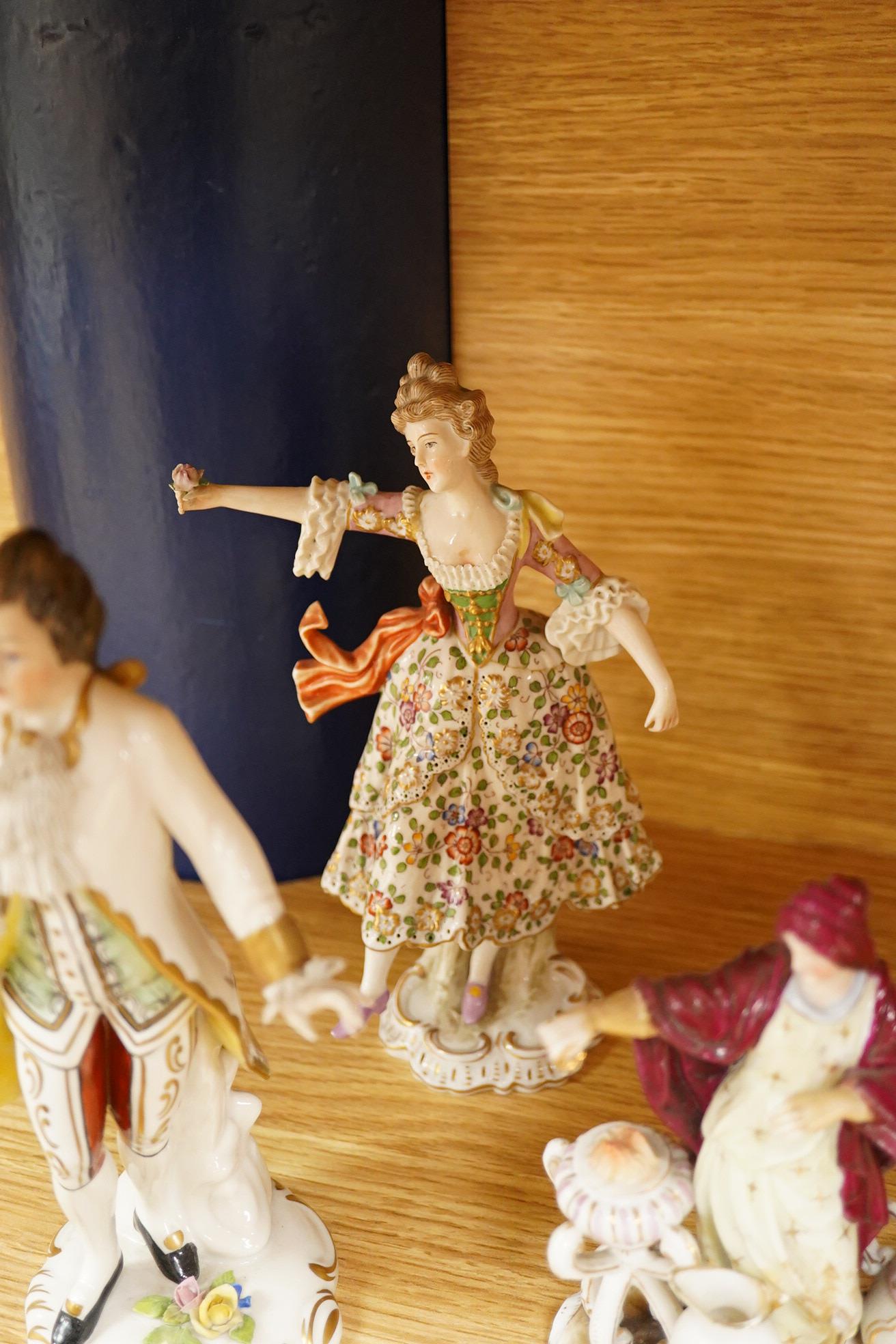 Nine continental figurines, to include Dresden porcelain lace examples, together with a resin figurine of Queen Elizabeth, largest 23cm high